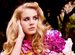 Lana Del Ray in a forest looking off in the distance.