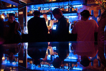 Men drinking at the reflective bar at Slowly in Florence. 