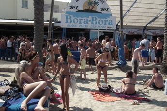 Girls in bikinis at Bora Bora beach bar in Ibiza.