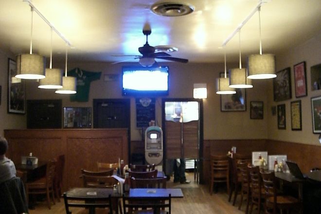 The back of the bar at Paddy Long's with entrance to kitchen, ATM, and bathrooms.