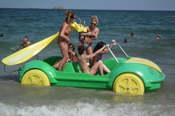 Girls frolicking on the beach in Ibiza.